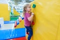 Little Girl Climbing a Rock Wall Indoor Royalty Free Stock Photo