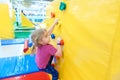 Little Girl Climbing a Rock Wall Indoor Royalty Free Stock Photo