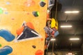 little girl climbing a rock wall indoor Royalty Free Stock Photo