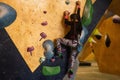 little girl climbing a rock wall indoor Royalty Free Stock Photo