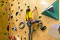 little girl climbing a rock wall indoor Royalty Free Stock Photo