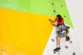 Little Girl Climbing Rock Wall practical wall in gym Royalty Free Stock Photo