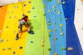 Little Girl Climbing Rock Wall practical wall in gym Royalty Free Stock Photo