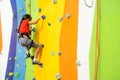 Little Girl Climbing Rock Wall practical wall in gym Royalty Free Stock Photo