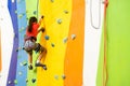 Little Girl Climbing Rock Wall practical wall in gym Royalty Free Stock Photo