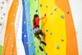 Little Girl Climbing Rock Wall practical wall in gym Royalty Free Stock Photo