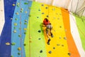 Little Girl Climbing Rock Wall practical wall in gym Royalty Free Stock Photo