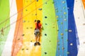 Little Girl Climbing Rock Wall practical wall in gym Royalty Free Stock Photo