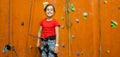 Little Girl Climbing Rock Wall practical wall in gym Royalty Free Stock Photo