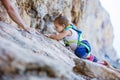 Little girl climbing up cliff Royalty Free Stock Photo