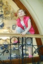 Little girl climbs onto railing and looks upward