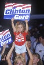 Little girl with Clinton/Gore sign stands out in the crowd during the Clinton/Gore 1992 Buscapade campaign tour in Tyler, Texas