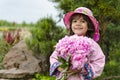 The little girl close in a pink hat and a raincoat