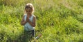 Little girl closed her eyes praying at sunset. Hands folded in prayer concept for faith, spirituality and religion. Hope, concept. Royalty Free Stock Photo