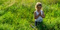 Little girl closed her eyes praying at sunset. Hands folded in prayer concept for faith, spirituality and religion. Hope, concept. Royalty Free Stock Photo