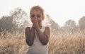 Little girl closed her eyes praying at sunset. Hands folded in prayer concept for faith, spirituality and religion. Hope, concept.