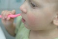 A little girl clumsily cleans her teeth. Royalty Free Stock Photo