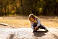 Little girl in coat in autumn plays with toy car on remote control in Park Royalty Free Stock Photo