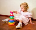 Little girl collects pyramid Royalty Free Stock Photo