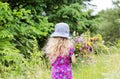 Little girl collects wild flowers