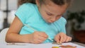 Little girl coloring craftwork at home