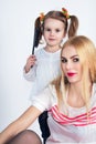 Little girl combing her hair mom Royalty Free Stock Photo