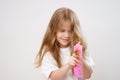 little girl combs long hair. white background.