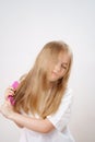 little girl combs long and tangled hair. white background.