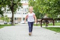 A little girl comes with a backpack for lessons. The concept of school, study, education, friendship, childhood. Royalty Free Stock Photo