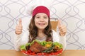 Little girl cook with big drumstick and thumbs up Royalty Free Stock Photo