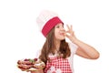 Little girl cook with cherry pie dessert and ok hand sign