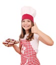 Little girl cook with cherry pie dessert and thumb up