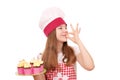 Little girl cook with muffins and ok hand sign Royalty Free Stock Photo