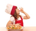 Little girl cook with ok sign and salmon on dish