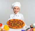 Little girl-cook with pizza in hands Royalty Free Stock Photo