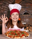 Little girl cook with pizza and ok hand sign Royalty Free Stock Photo