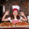 Little girl cook with pizza and ok hand sing Royalty Free Stock Photo