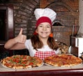 Little girl cook with pizza and thumb up Royalty Free Stock Photo