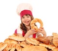 Little girl cook with pretzels bread and buns Royalty Free Stock Photo