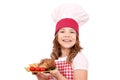 Little girl cook with roasted chicken wings franch fries a