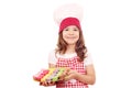 Little girl cook with sweet macarons