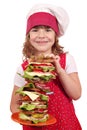 Little girl cook with tall sandwich