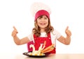 Little girl cook with thumbs up and white swan decorated s Royalty Free Stock Photo