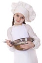 Little girl cook whips whisk eggs in a large plate Royalty Free Stock Photo