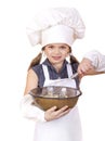 Little girl cook whips whisk eggs in a large plate Royalty Free Stock Photo