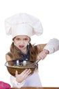 Little girl cook whips whisk eggs in a large plate Royalty Free Stock Photo