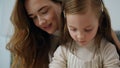 Little girl cooking with tender woman kitchen portrait. Mother embracing child Royalty Free Stock Photo