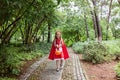 Little Girl in costume of red hat in the park. Happy Halloween concept
