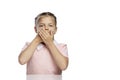 The little girl covered her mouth with her hands. Isolated over white background Royalty Free Stock Photo