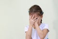 little girl covers her face with her hands in fear Royalty Free Stock Photo